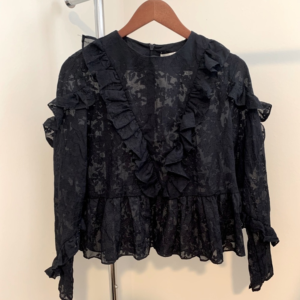 Sheer blouse with floral pattern.